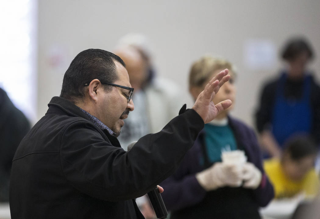 Pastor Fernando Anguiano prays before the start of the Las Vegas Rescue Mission's annual Thanks ...