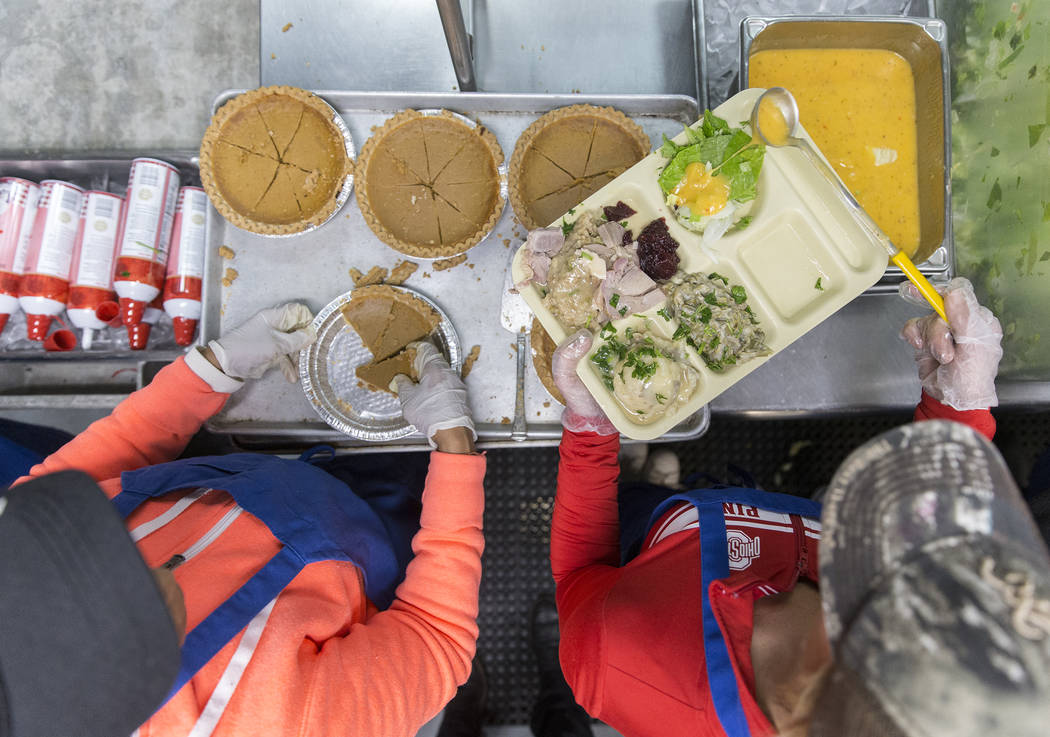 Volunteers Jamie Almasi, right, and Edna Sanders prepare trays of food during the Las Vegas Res ...