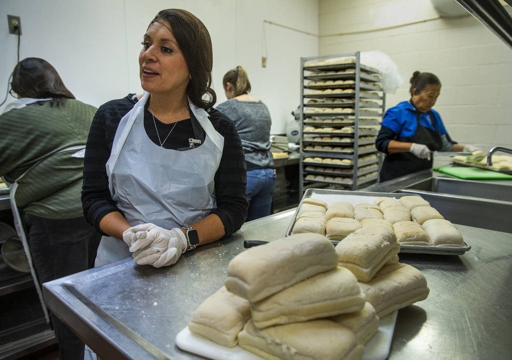 Volunteer Selva Montoya helps to prepare loaves of bread as Catholic Charities of Southern Neva ...