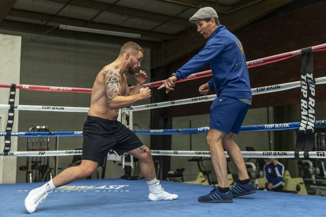Former two-weight world boxing champion Carl Frampton, left, works on his footing with trainer ...