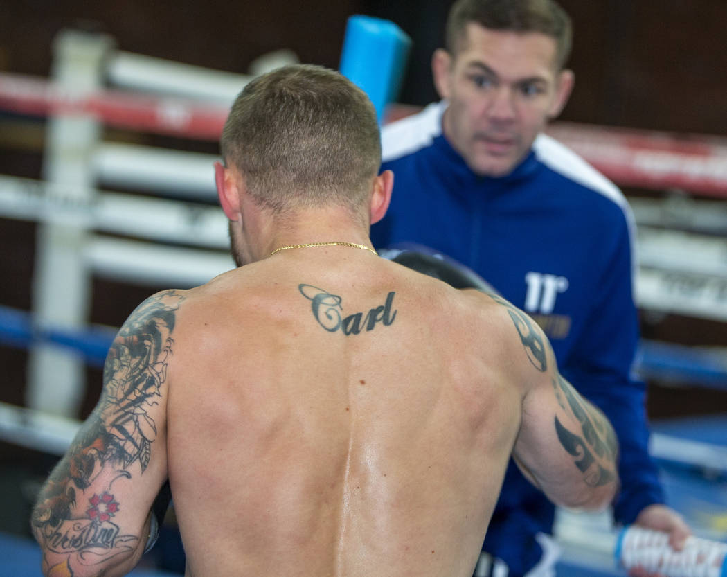 Former two-weight world boxing champion Carl Frampton boxes with trainer Jamie Moore, facing, a ...