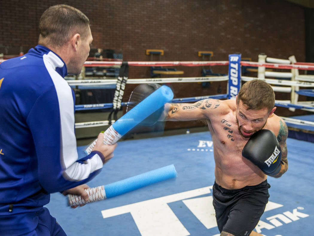 Former two-weight world boxing champion Carl Frampton, right, boxes with trainer Jamie Moore at ...