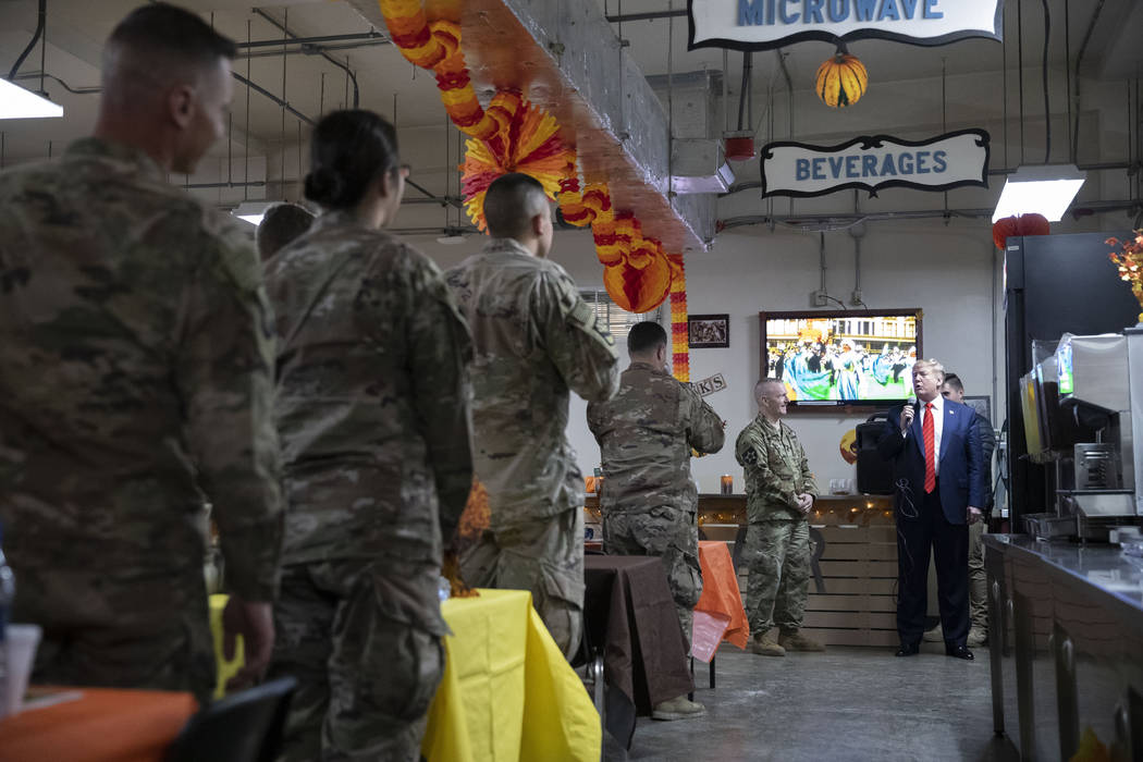 President Donald Trump speaks during a surprise Thanksgiving Day visit to the troops, Thursday, ...
