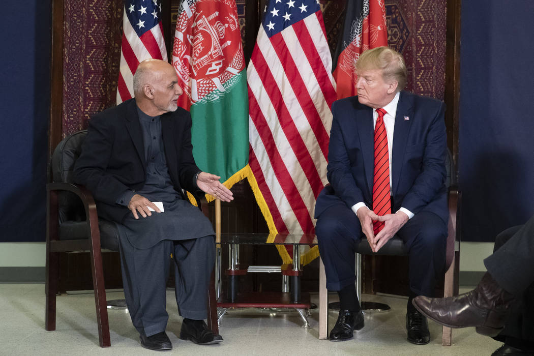 President Donald Trump listens during a meeting with Afghan President Ashraf Ghani during a sur ...