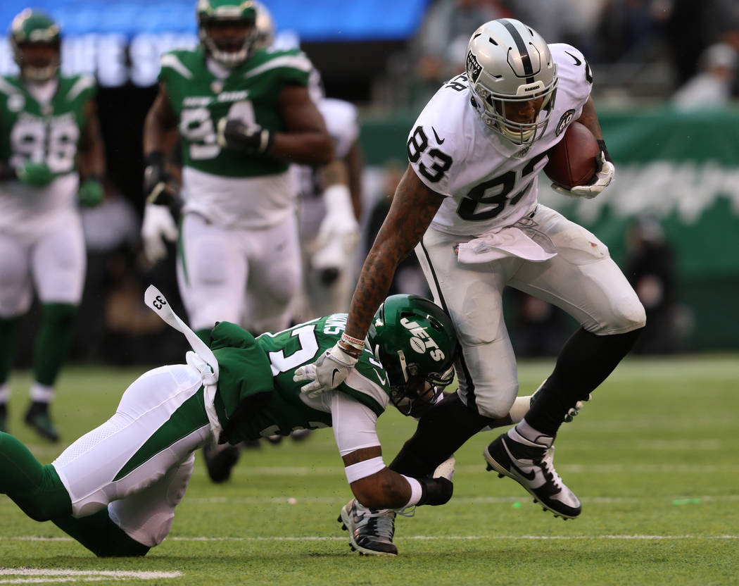 Oakland Raiders tight end Darren Waller (83) tries to break a tackle by New York Jets strong sa ...