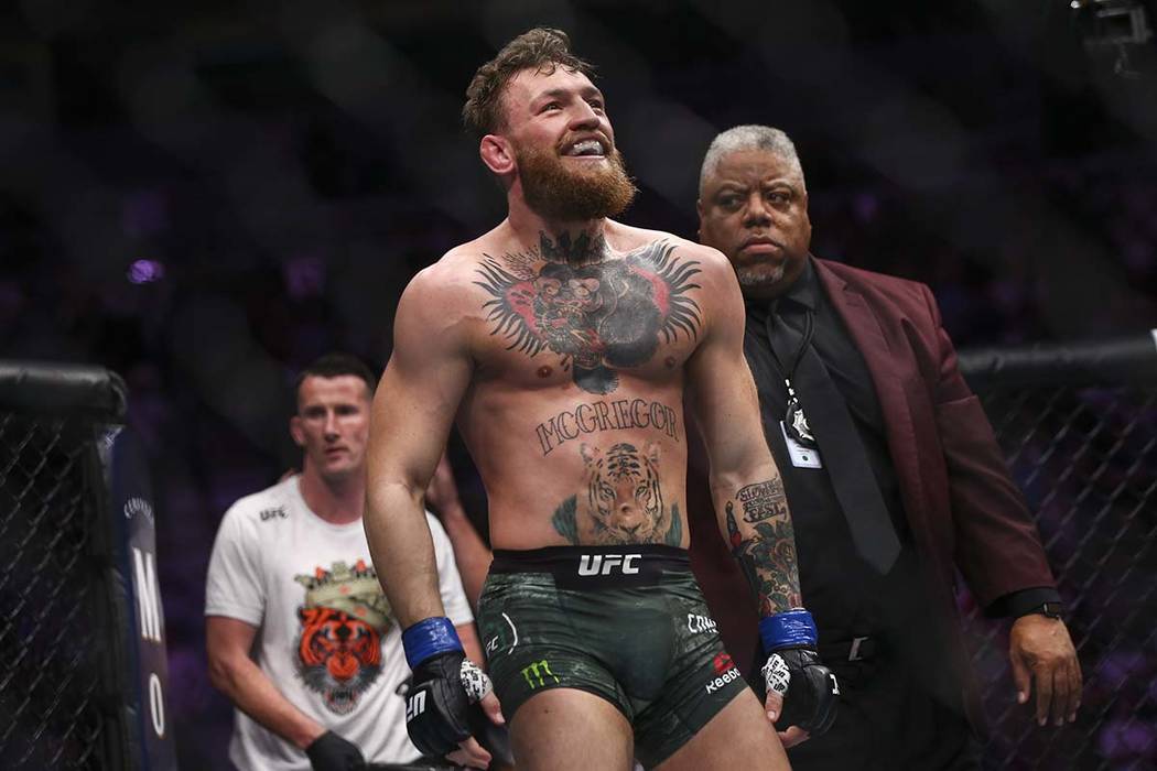 Conor McGregor reacts at the end of a round during his fight against Khabib Nurmagomedov in a l ...