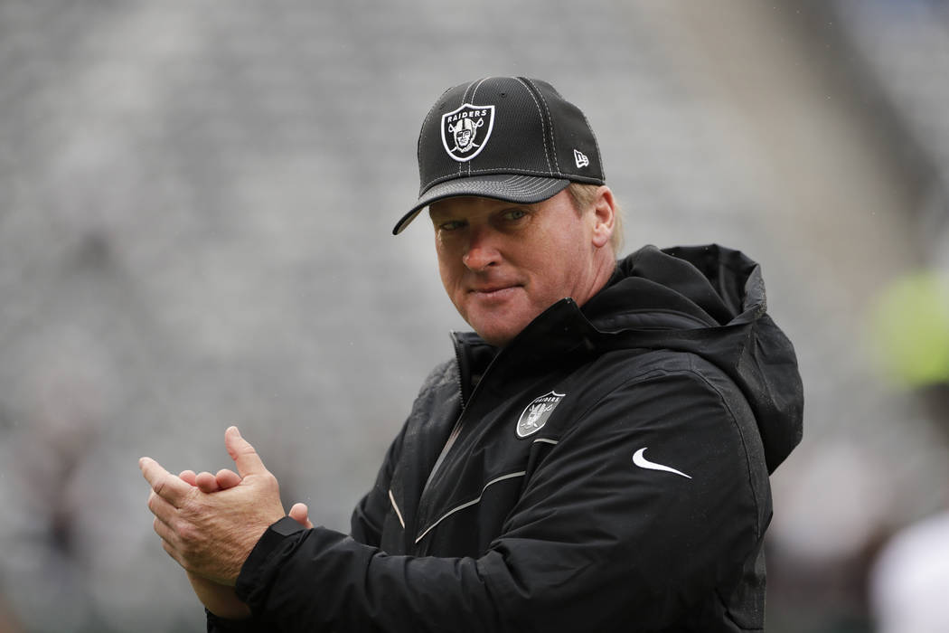 Oakland Raiders head coach Jon Gruden watches his team warm up before an NFL football game agai ...