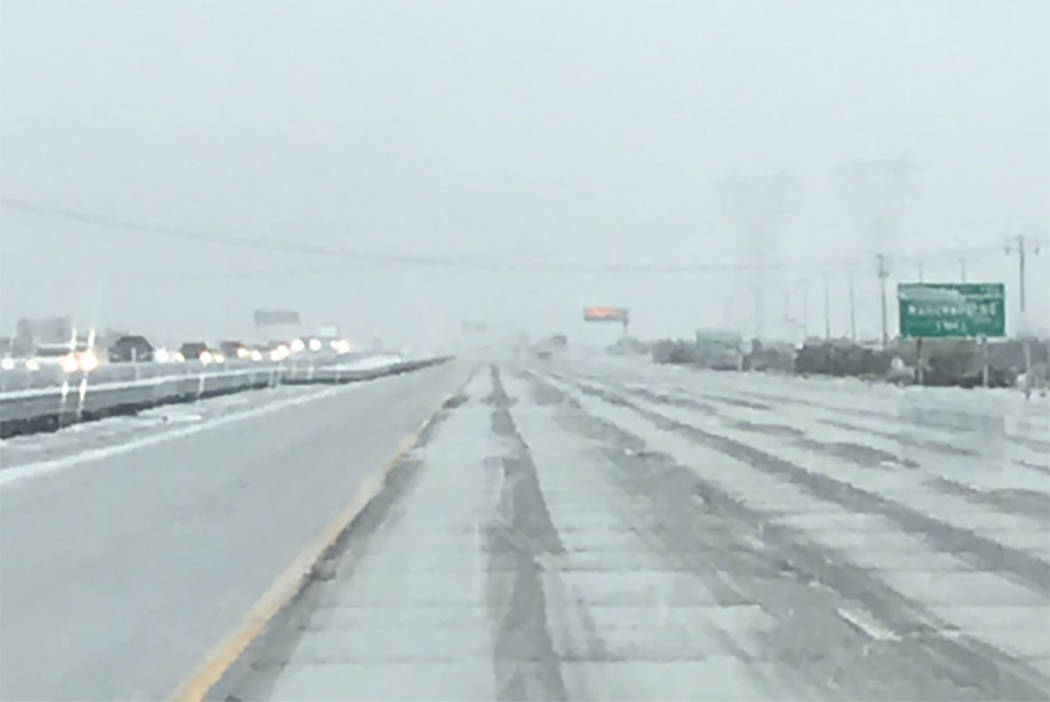 Snow falls on Interstate 15 in Hesperia, Calif., on Thursday, Nov. 28, 2019. (Caltrans District ...