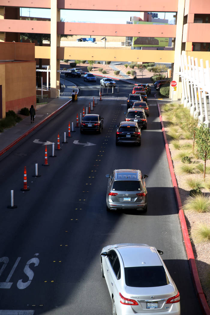 Cars file into a parking garage at Las Vegas North Premium Outlets before opening on Thanksgivi ...
