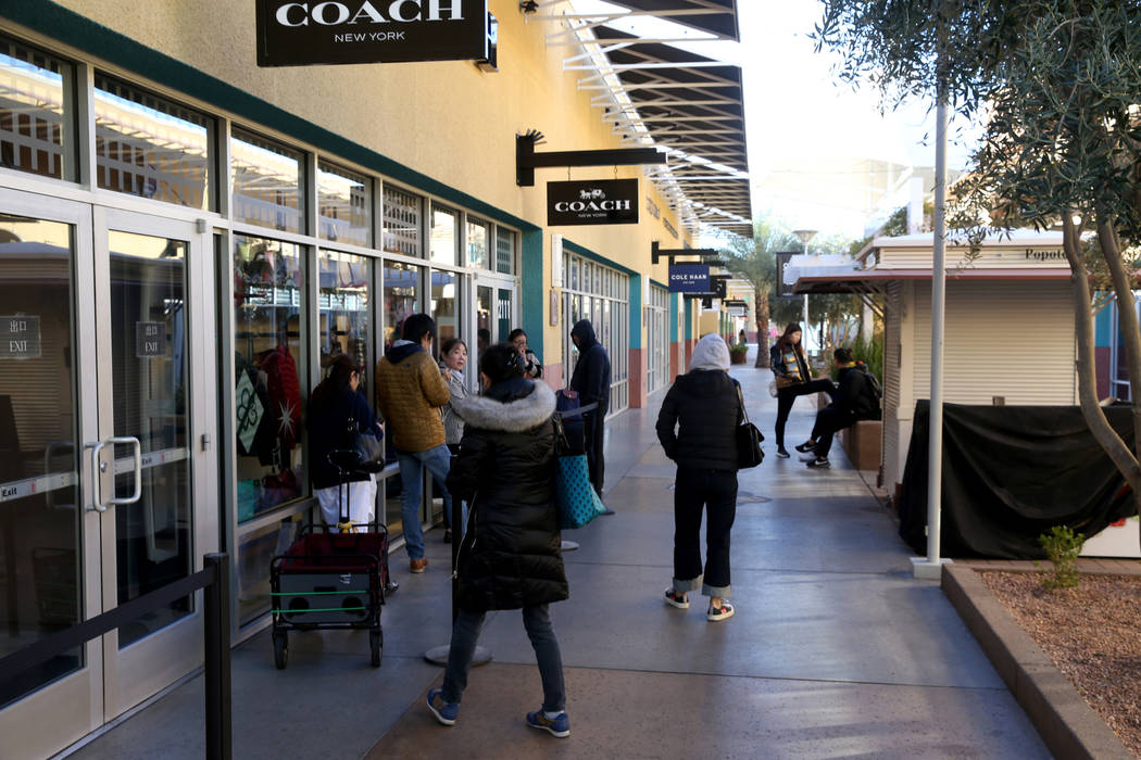 People line up at the Coach store at Las Vegas North Premium Outlets before opening on Thanksgi ...