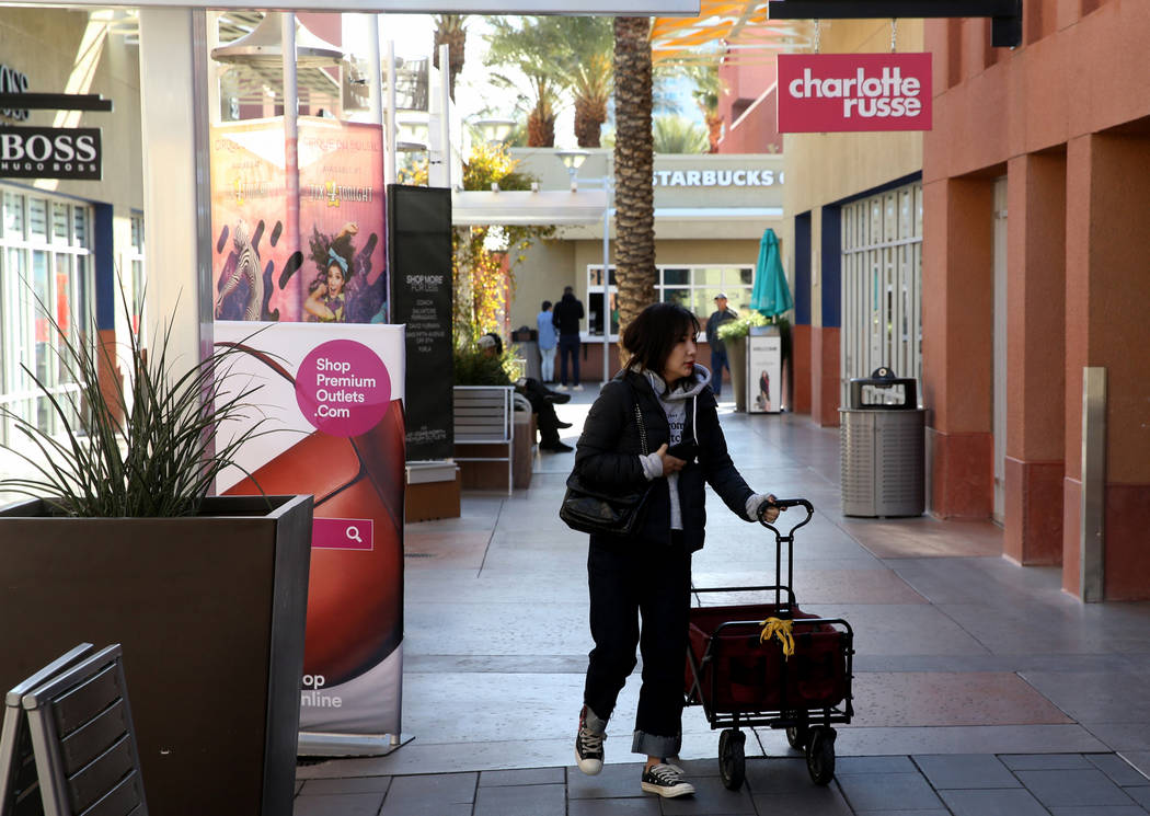 Rachel Xu of Los Angeles prepares her wagon before opening at Las Vegas North Premium Outlets o ...