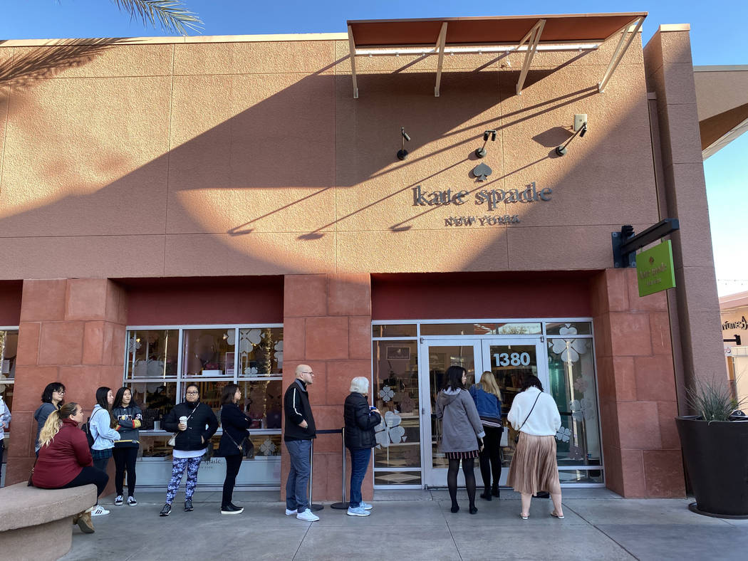 People line up at the Kate Spade New York store at Las Vegas North Premium Outlets before openi ...