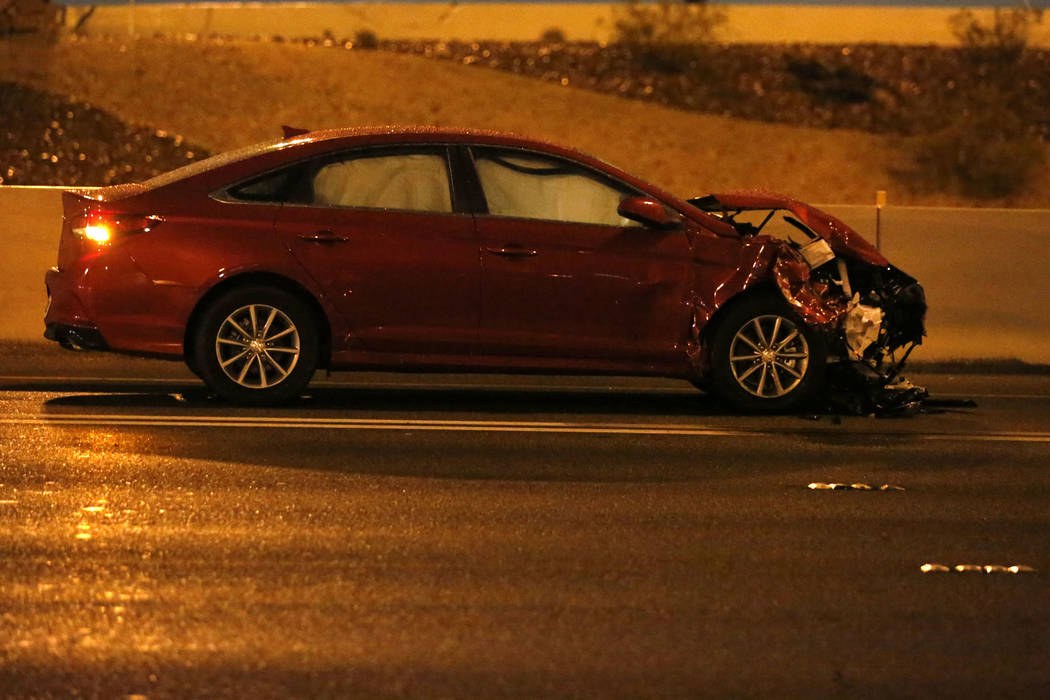 A damaged car is seen after a fatal crash on U.S. Highway 95 near Lake Mead Boulevard, Thursday ...
