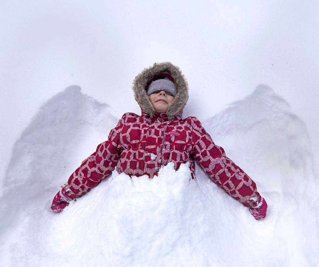 Maria Kutanova, 8, of Las Vegas makes a snow angel on Thursday, Nov. 28, 2019, at Upper Lee Mea ...