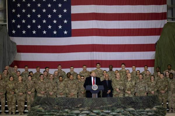 President Donald Trump addresses members of the military during a surprise Thanksgiving Day vis ...
