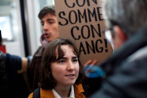 An activist blocks a shopping center, in the business district of Paris, La Défense, in Pa ...