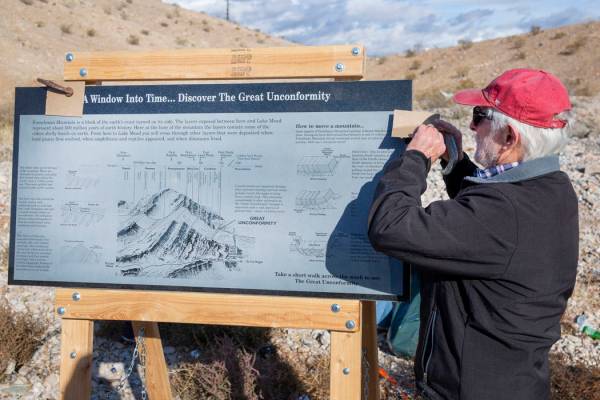 UNLV Geology Professor Steve Rowland sets up a granite sign explaining the history of the Great ...