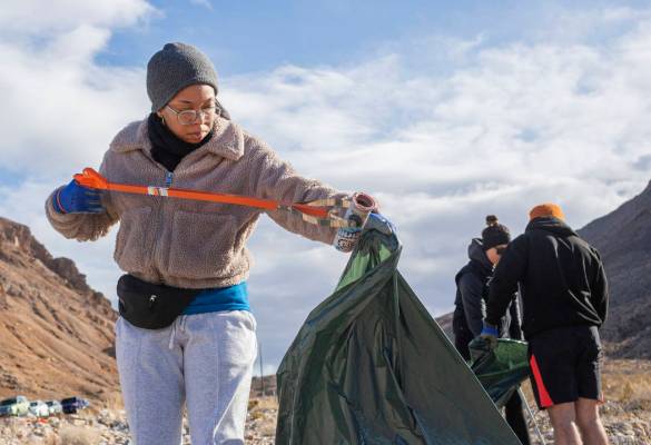 Volunteer for Get Outdoors Nevada Jasmine Upperman of Los Angeles cleans up trash near the trai ...
