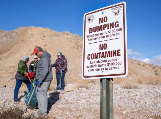 Volunteers for Get Outdoors Nevada clean up garbage near the trail leading to the Great Unconfo ...