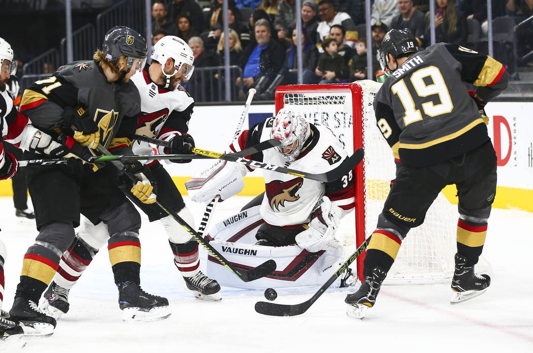 Arizona Coyotes goaltender Darcy Kuemper (35) blocks a shot from Golden Knights' Reilly Smith ( ...