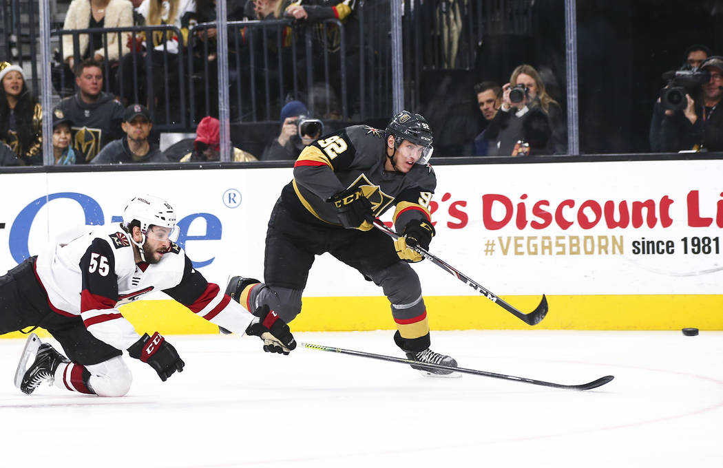 Golden Knights' Tomas Nosek (92) shoots the puck in front of Arizona Coyotes' Jason Demers (55) ...