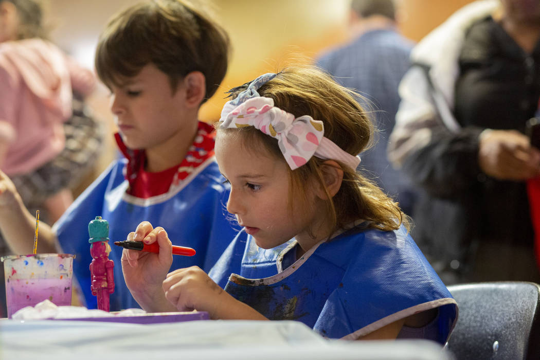 Harley Taylor, 5, of Las Vegas, paints a nutcracker ornament at Discovery Children's Museum's e ...