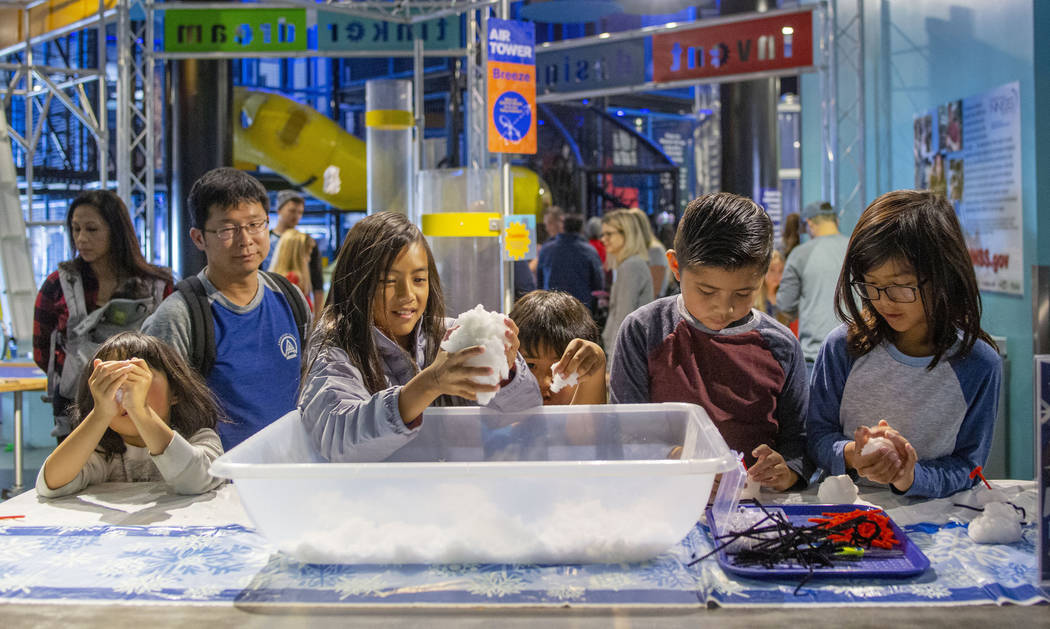 Kids make miniature snowmen at a craft table during the Discovery Children's Museum's eighth an ...