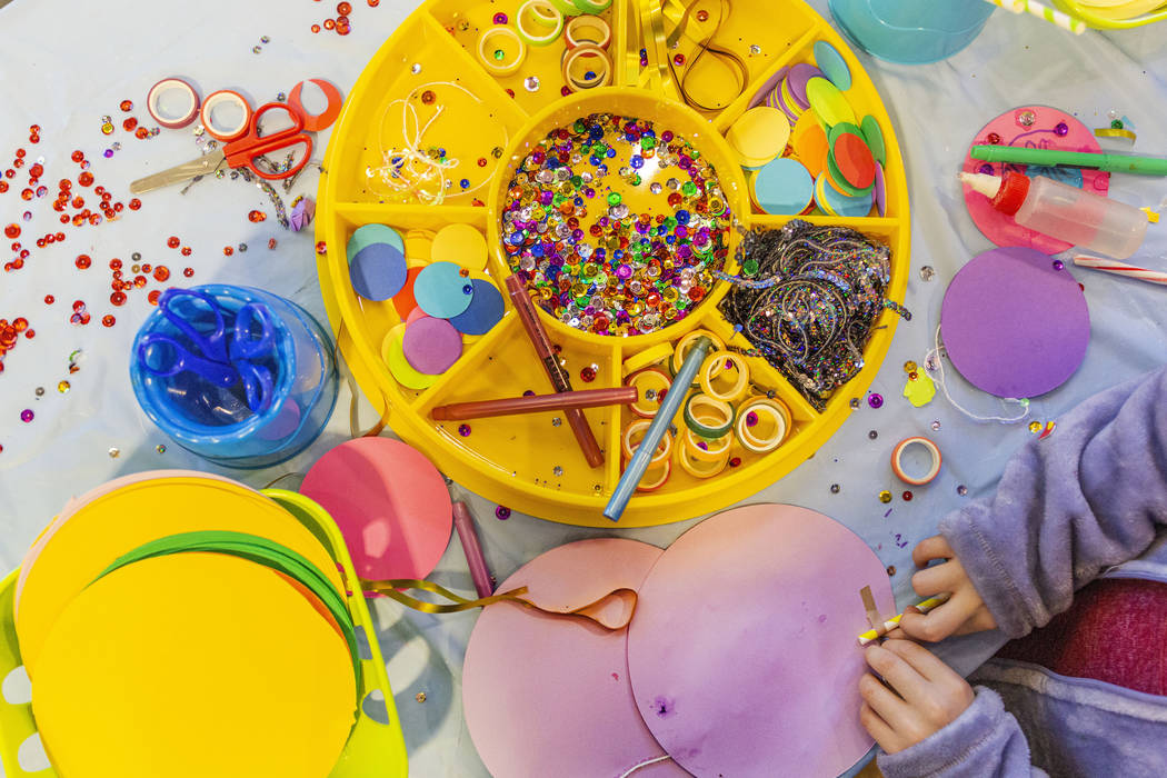 Kids make paper lollipops at a craft station during the Discovery Children's Museum's eighth an ...