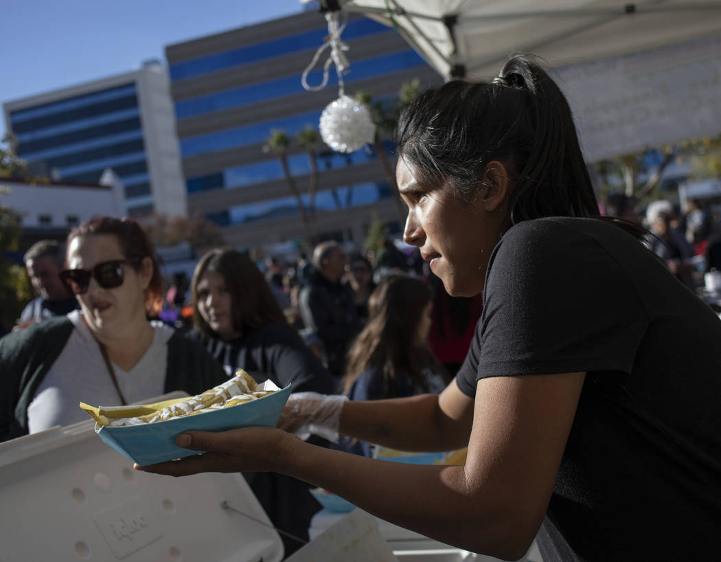 Rosa Anaya, right, of Gourmet Tamales, serves tamales at the Las Vegas Tamale & Mariachi Fe ...