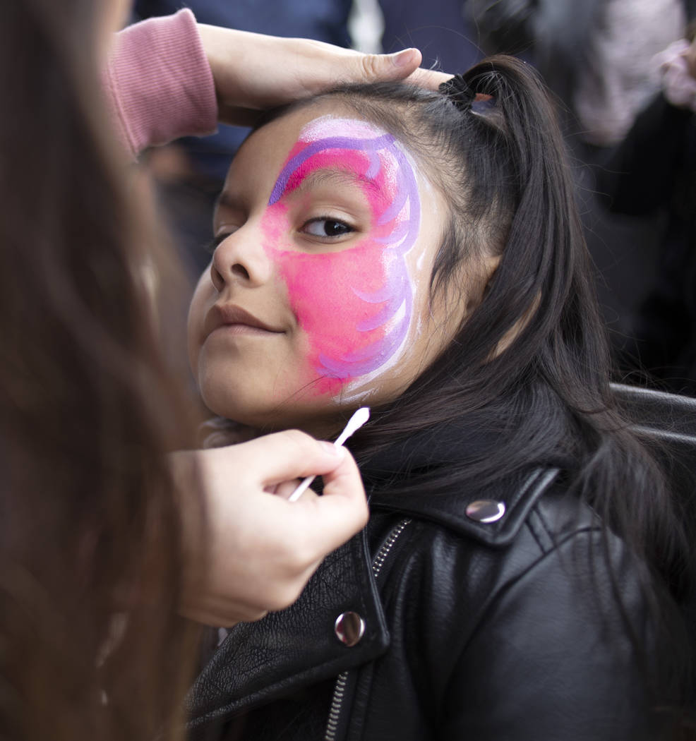 Violet Hernandez, 5, has a butterfly mask painted on her face at the Las Vegas Tamale & Mar ...