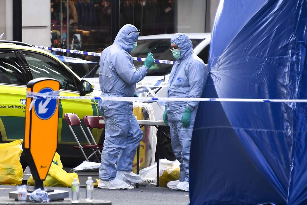 Forensic workers attend the scene on London Bridge in London, Saturday, Nov. 30, 2019. UK count ...