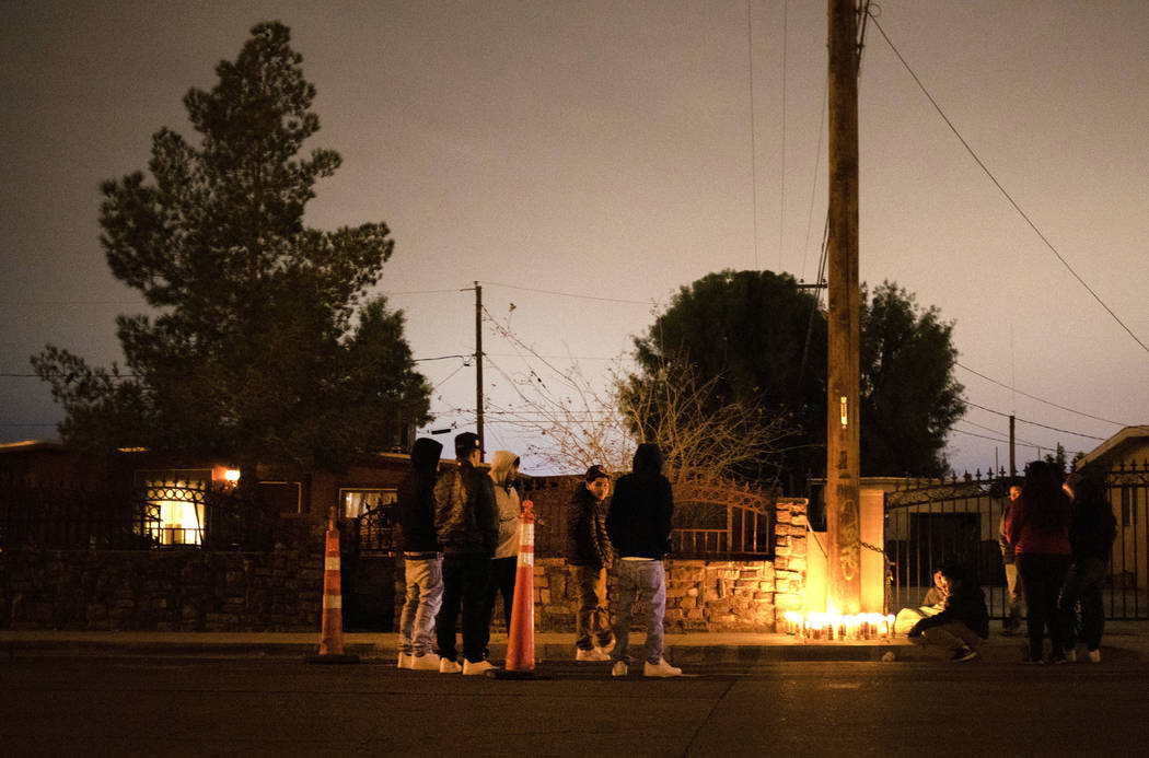 People gather to mourn a 17-year-old boy who was shot and killed this morning near the 2600 blo ...