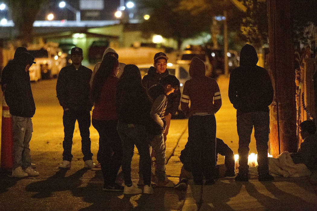 People gather to mourn a 17-year-old boy who was shot and killed this morning near the 2600 blo ...