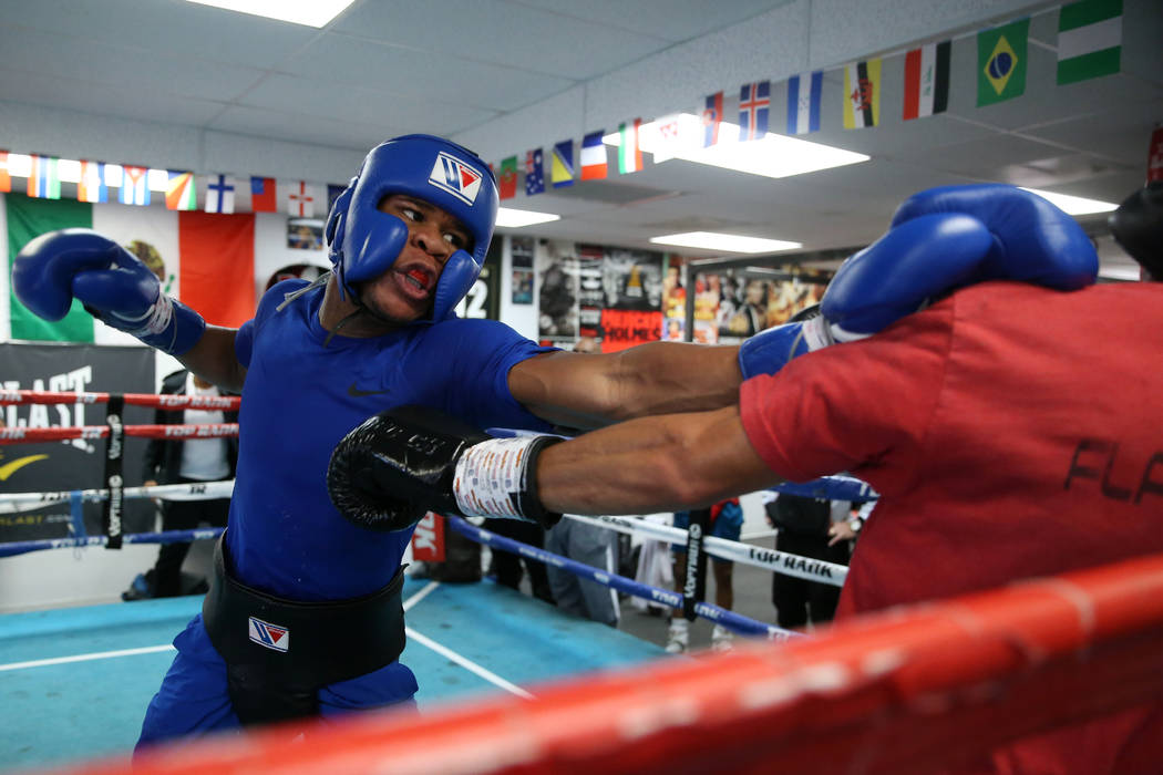 Boxer Devin Haney, left, connects a punch against Cesar Valenzuela while sparring in preparatio ...