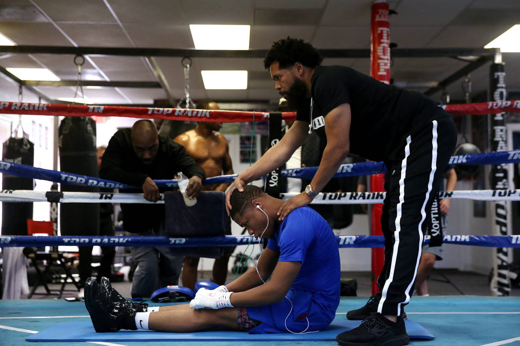 Boxer Devin Haney, left, with his father and trainer William "Bill" Haney, stretch before sparr ...