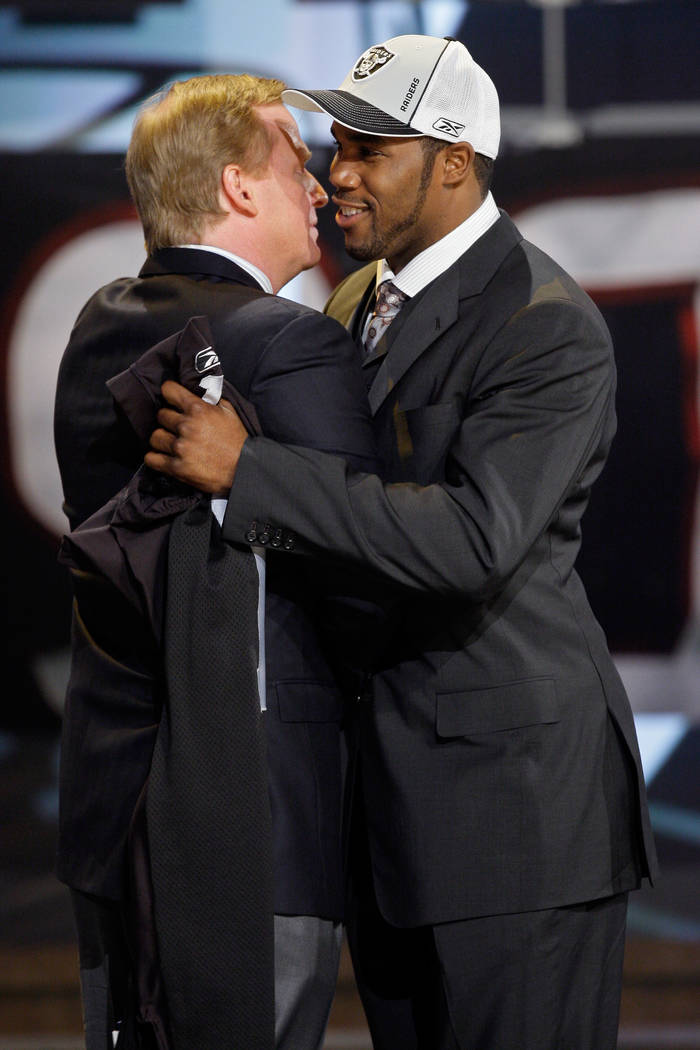 NFL commissioner Roger Goodell, left, hugs Darren McFadden, the fourth overall pick by the Oakl ...
