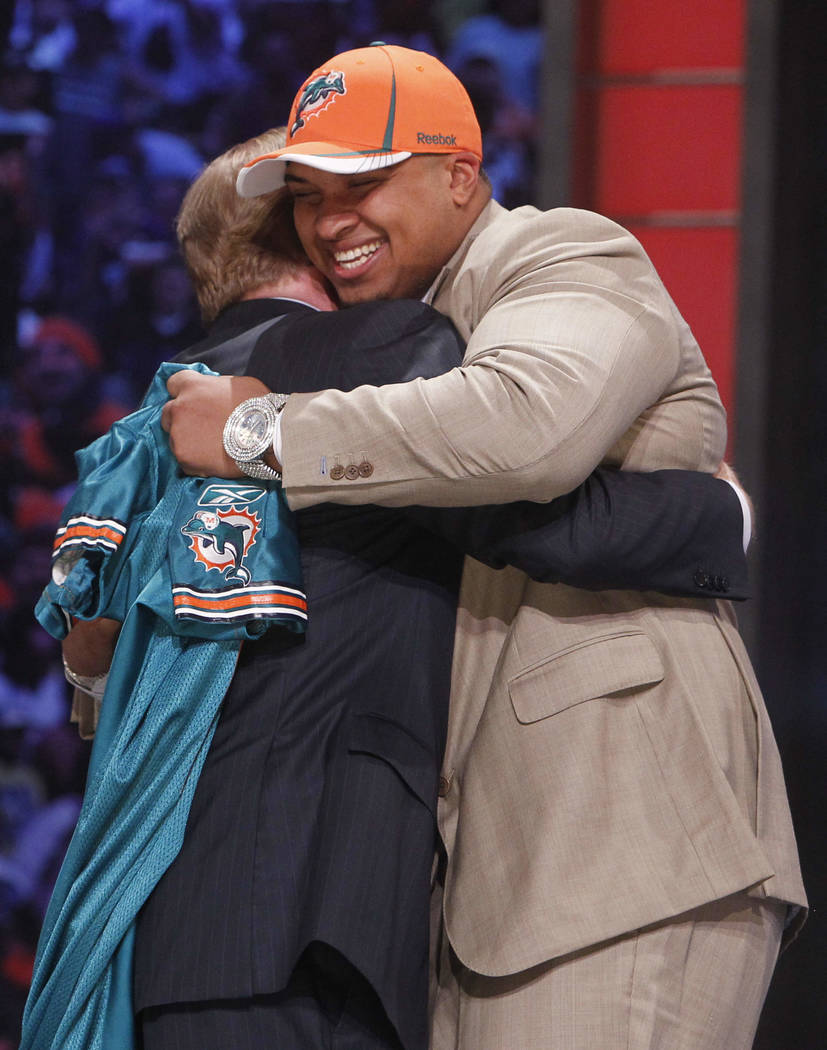 Florida offensive lineman Mike Pouncey hugs NFL commissioner Roger Goodell after he was selecte ...