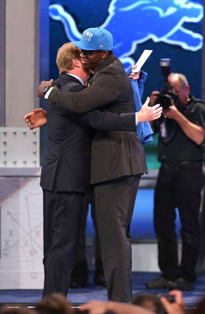 Ezekiel Ansah, from Brigham Young, hugs NFL Commissioner Roger Goodell after being selected fif ...