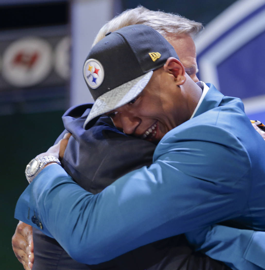 Ohio State outside linebacker Ryan Shazier hugs NFL commissioner Roger Goodell after being sele ...
