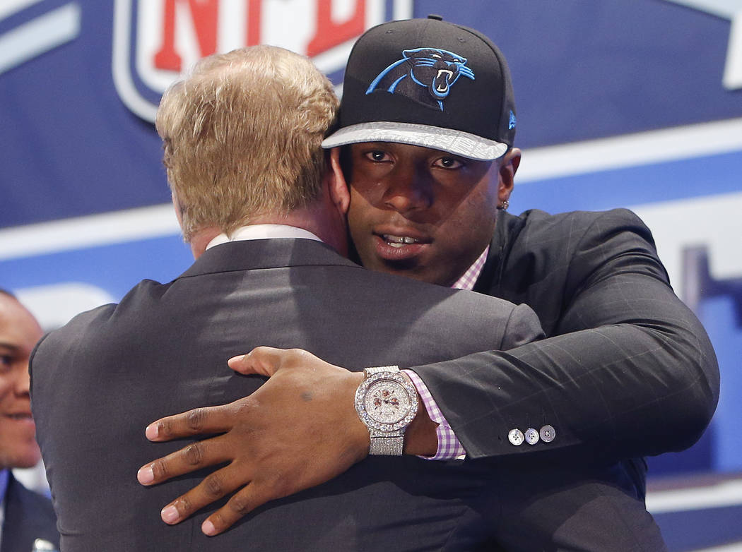 Missouri defensive end Kony Ealy hugs NFL commissioner Roger Goodell after being selected as th ...