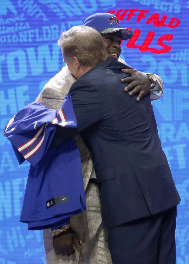 Clemsons Shaq Lawson embraces with NFL commissioner Roger Goodell after being selected by the B ...