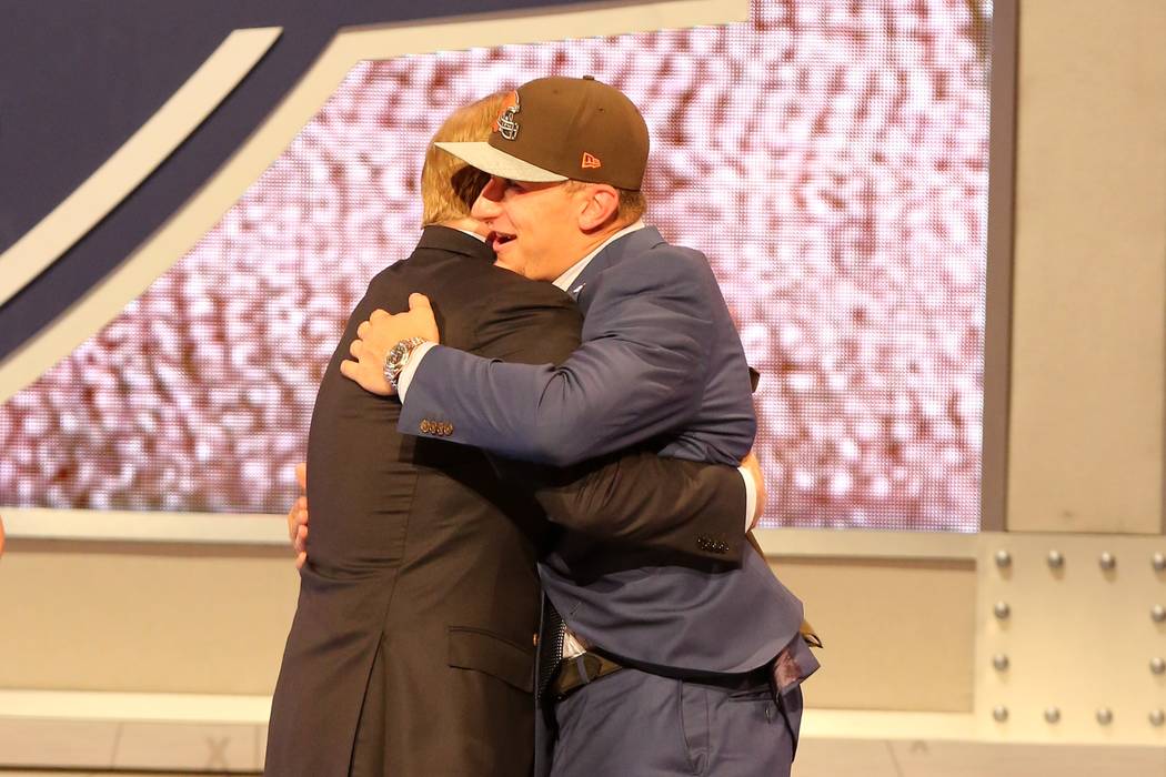 Johnny Manziel hugs NFL Commissioner Roger Goodell after being selected by the Cleveland Browns ...