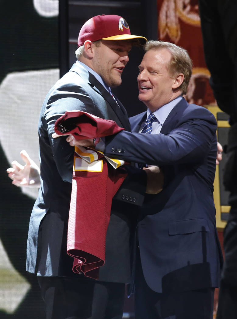 Iowa offensive lineman Brandon Scherff hugs NFL commissioner Roger Goodell after being selected ...