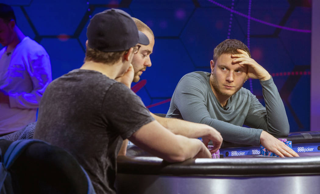 Kahle Burns, left, Sean Winter and Sam Soverel play on the main table during the 2019 Poker Mas ...
