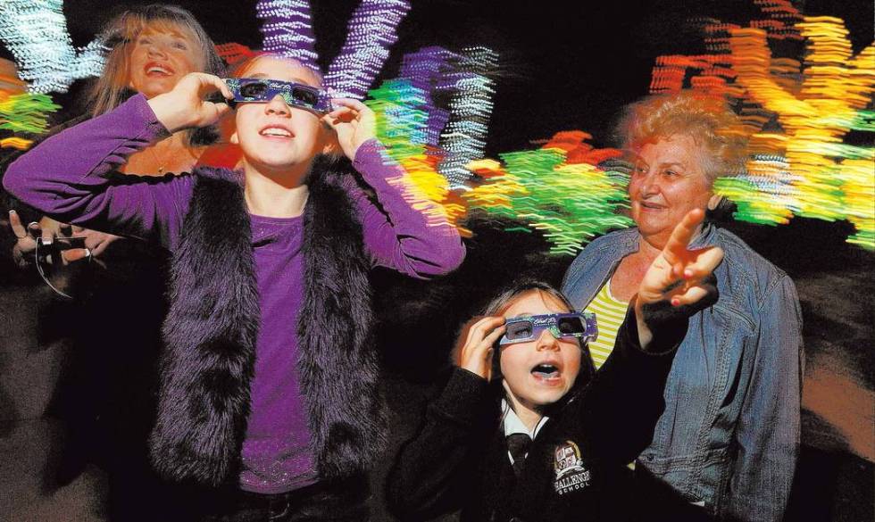 Sienna Tobler, 10, left, and Katie Kriey, 7, use 3-D glasses to admire the lights as Mary Ann O ...