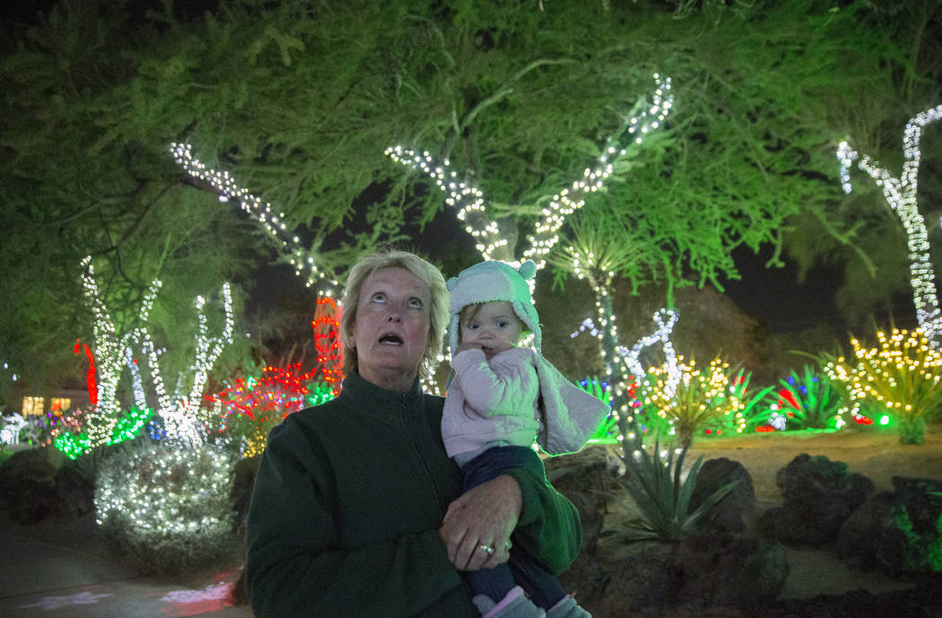 Cheryl Frazier, left, holds her granddaughter McKenna Dillon, 1, as they walk through Ethel M C ...