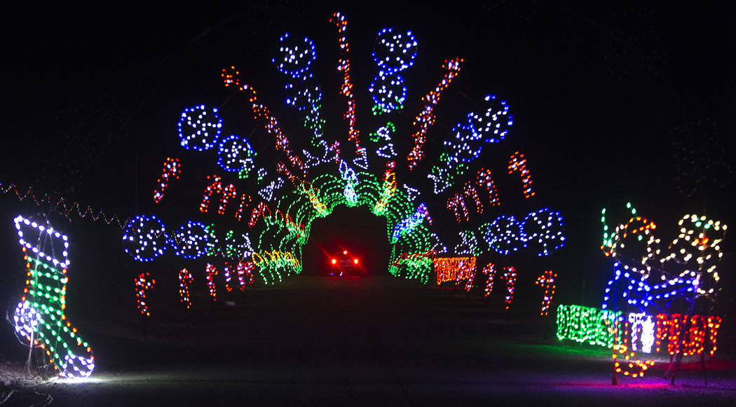 Vehicles drive through Glittering Lights on Sunday, Nov. 10, 2019, at Las Vegas Motor Speedway ...