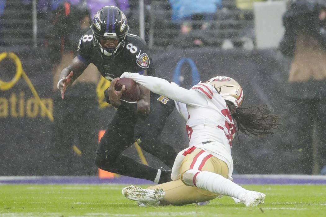 San Francisco 49ers defensive back Marcell Harris (36) strips the ball from Baltimore Ravens qu ...