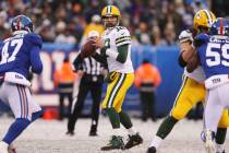 Green Bay Packers quarterback Aaron Rodgers (12) looks to make a pass while New York Giants out ...
