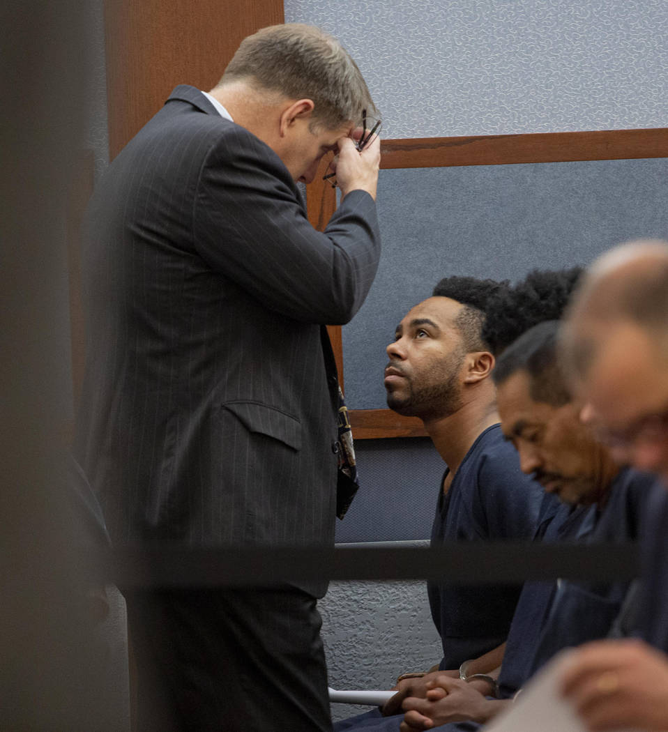 Defense attorney Greg Mueller, left, speaks to Nathaniel Postelle during a hearing at the Regio ...